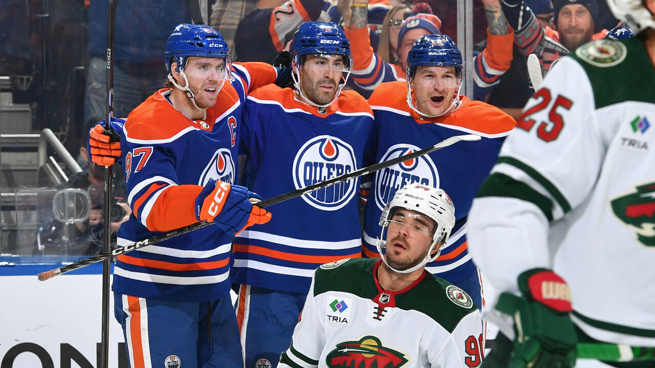 EDMONTON, CANADA - DECEMBER 08: Evan Bouchard #2 of the Edmonton Oilers celebrates after a first period goal against the Minnesota Wild with Connor McDavid #97 and Zach Hyman #18 at Rogers Place on December 8, 2023, in Edmonton, Alberta, Canada.