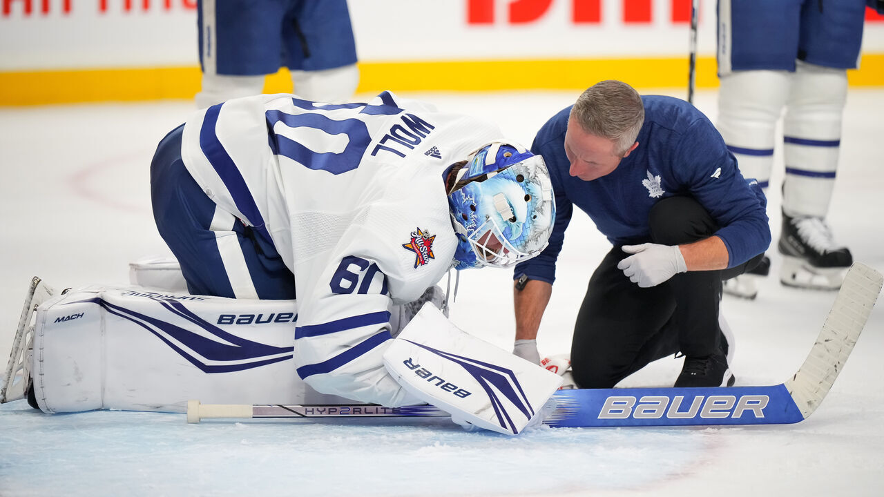 OTTAWA, CANADA - DECEMBER 7: Joseph Woll #60 of the Toronto Maple Leafs speaks to an athletic trainer during a stoppage in play after sustaining an injury against the Ottawa Senators during the third period at Canadian Tire Centre on December 7, 2023 in Ottawa, Ontario, Canada.