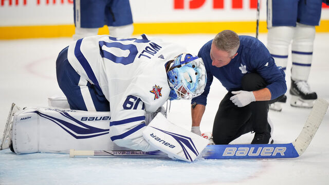 OTTAWA, CANADA - DECEMBER 7: Joseph Woll #60 of the Toronto Maple Leafs speaks to an athletic trainer during a stoppage in play after sustaining an injury against the Ottawa Senators during the third period at Canadian Tire Centre on December 7, 2023 in Ottawa, Ontario, Canada.