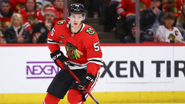 CHICAGO, IL - DECEMBER 07: Kevin Korchinski #55 of the Chicago Blackhawks controls the puck during the second period against the Anaheim Ducks at the United Center on December 7, 2023 in Chicago, Illinois.