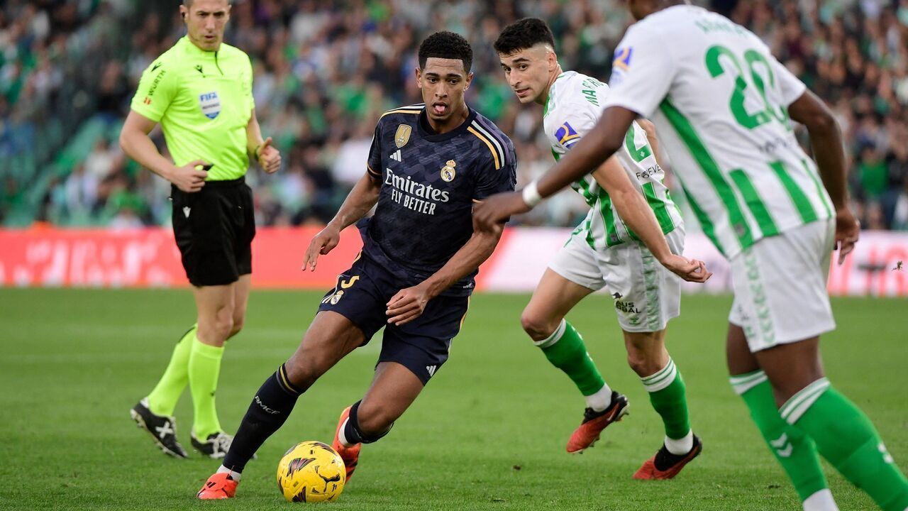 Real Madrid's English midfielder #5 Jude Bellingham runs with the ball during the Spanish league football match between Real Betis and Real Madrid CF at the Benito Villamarin stadium in Seville on December 9, 2023.