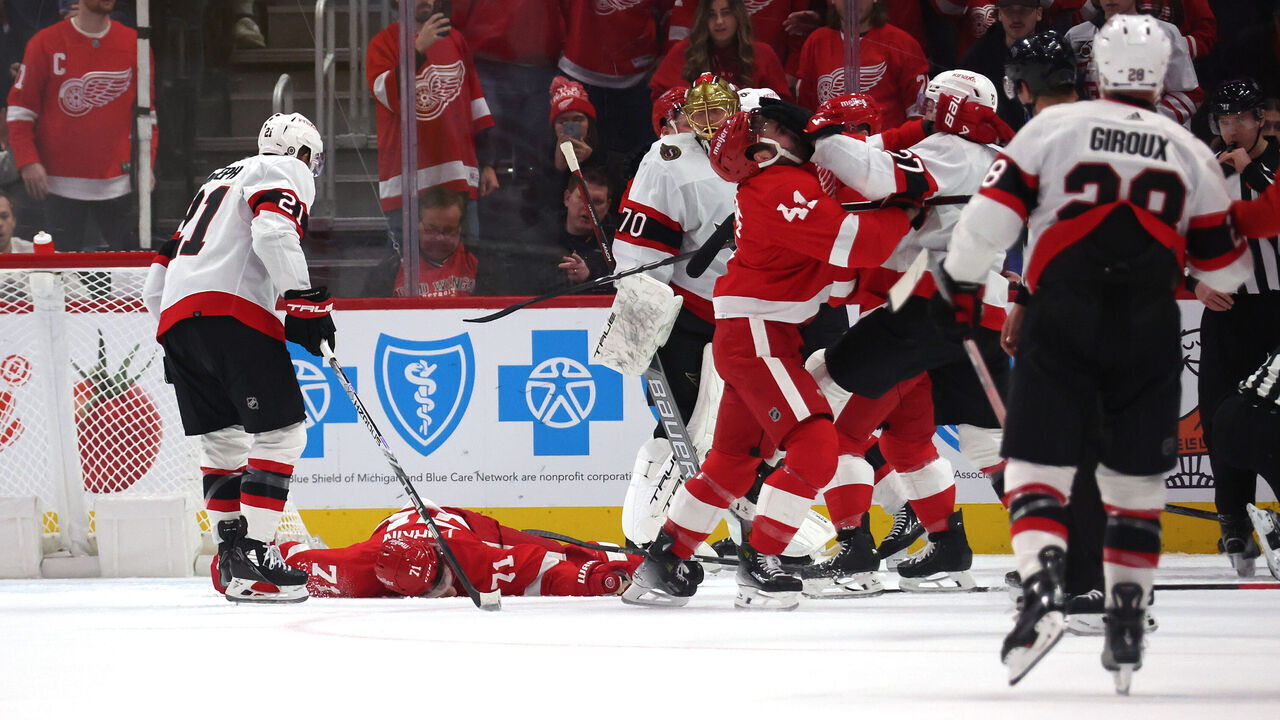 DETROIT, MICHIGAN - DECEMBER 09: Dylan Larkin #71 of the Detroit Red Wings is lays on the ice after being injured in the first period while playing the Ottawa Senators at Little Caesars Arena on December 09, 2023 in Detroit, Michigan.