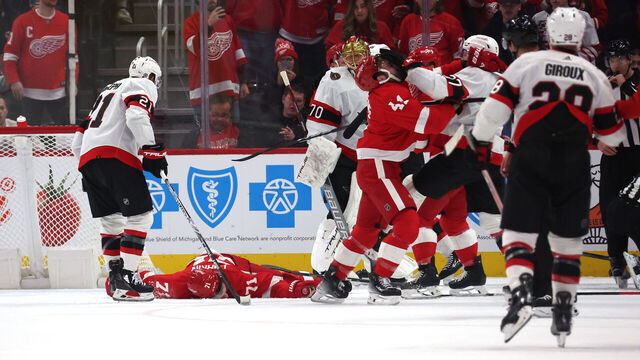 DETROIT, MICHIGAN - DECEMBER 09: Dylan Larkin #71 of the Detroit Red Wings is lays on the ice after being injured in the first period while playing the Ottawa Senators at Little Caesars Arena on December 09, 2023 in Detroit, Michigan.