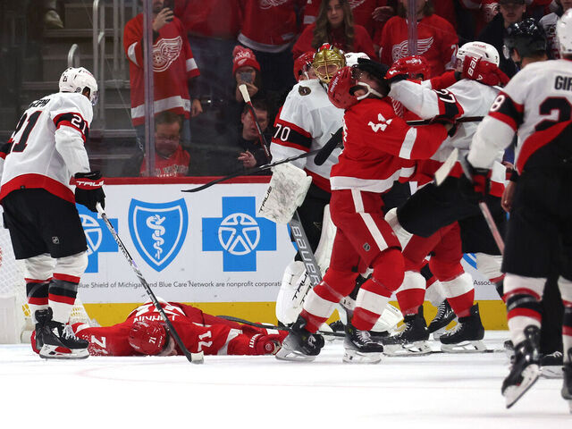 DETROIT, MICHIGAN - DECEMBER 09: Dylan Larkin #71 of the Detroit Red Wings is lays on the ice after being injured in the first period while playing the Ottawa Senators at Little Caesars Arena on December 09, 2023 in Detroit, Michigan.