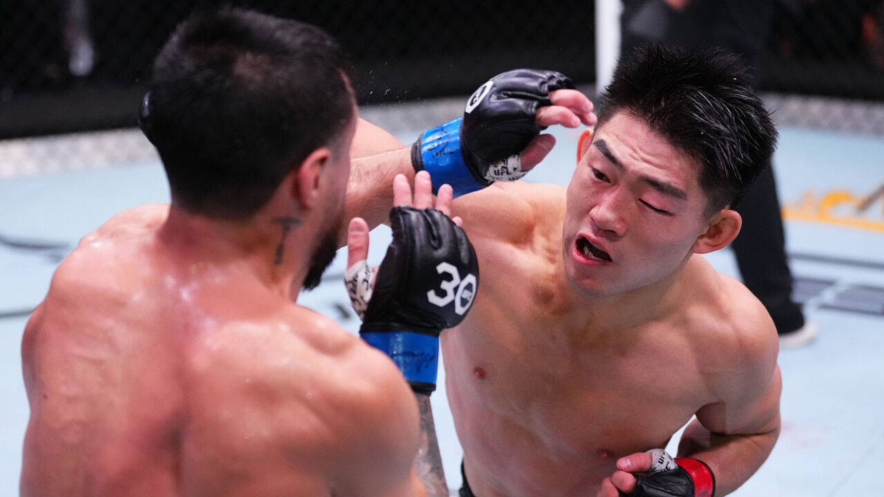 LAS VEGAS, NEVADA - DECEMBER 09: (R-L) Song Yadong of China punches Chris Gutierrez in a bantamweight fight during the UFC Fight Night event at UFC APEX on December 09, 2023 in Las Vegas, Nevada.
