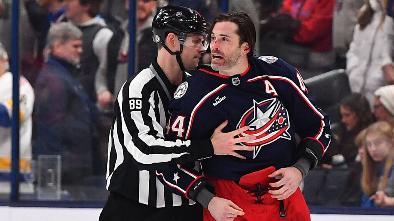 COLUMBUS, OHIO - DECEMBER 10: Erik Gudbranson #44 of the Columbus Blue Jackets is escorted to the bench by linesmen Joe Mahon #89 during the third period of a game against the Florida Panthers at Nationwide Arena on December 10, 2023 in Columbus, Ohio.