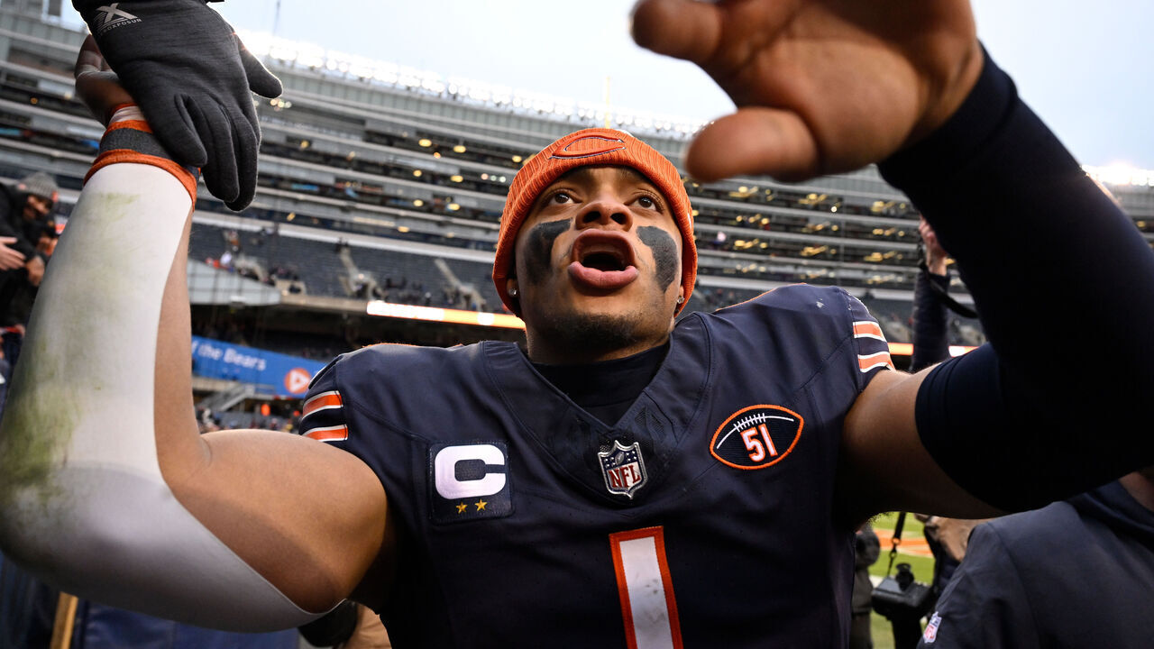 CHICAGO, ILLINOIS - DECEMBER 10: Justin Fields #1 of the Chicago Bears interacts with fans after a win over the Detroit Lions at Soldier Field on December 10, 2023 in Chicago, Illinois.