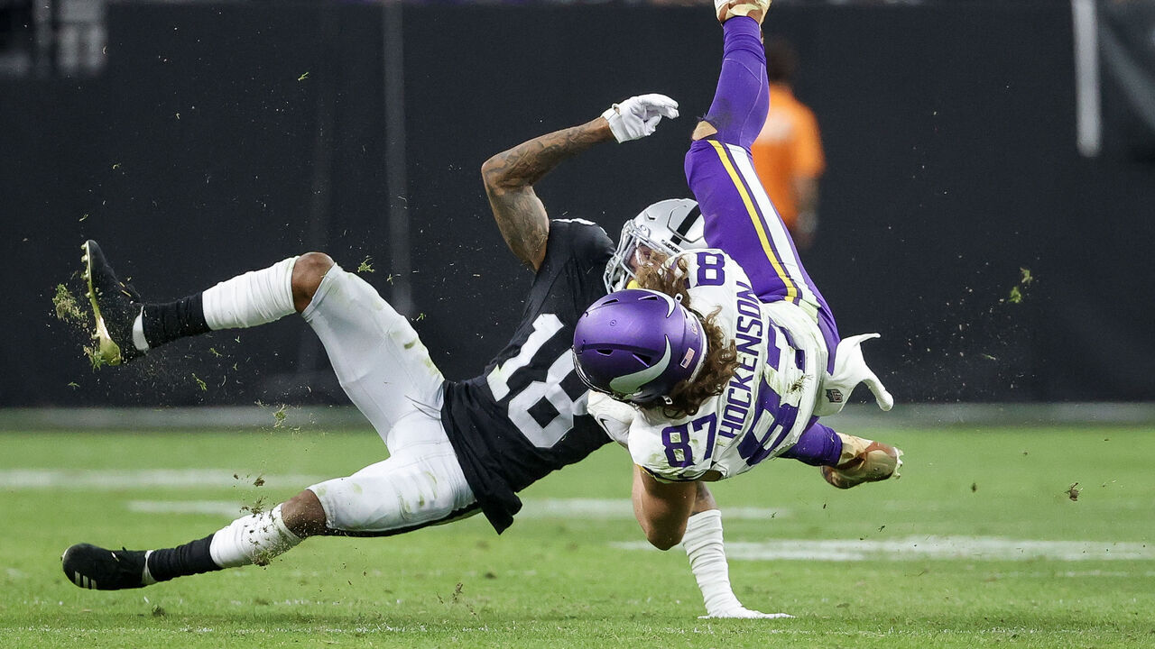 LAS VEGAS, NEVADA - DECEMBER 10: T.J. Hockenson #87 of the Minnesota Vikings is tackled by Jack Jones #18 of the Las Vegas Raiders during the second half of the game at Allegiant Stadium on December 10, 2023 in Las Vegas, Nevada.