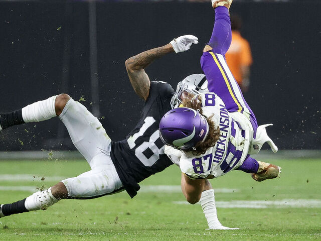 LAS VEGAS, NEVADA - DECEMBER 10: T.J. Hockenson #87 of the Minnesota Vikings is tackled by Jack Jones #18 of the Las Vegas Raiders during the second half of the game at Allegiant Stadium on December 10, 2023 in Las Vegas, Nevada.