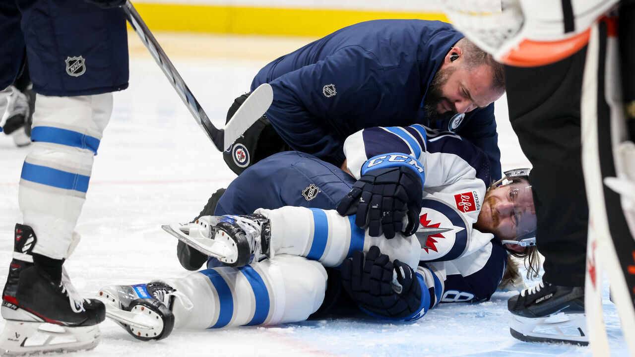 ANAHEIM, CA - DECEMBER 10: Kyle Connor #81 of the Winnipeg Jets falls to the ground after an apparent injury during the second period against the Anaheim Ducks at Honda Center on December 10, 2023 in Anaheim, California.