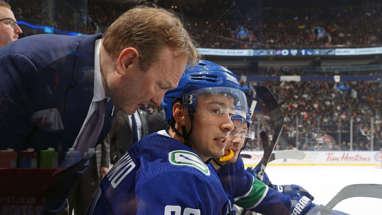VANCOUVER, CANADA - DECEMBER 09: Andrei Kuzmenko #96 of the Vancouver Canucks looks on from the bench during their NHL game against the Carolina Hurricanes at Rogers Arena on December 9, 2023 in Vancouver, British Columbia, Canada.