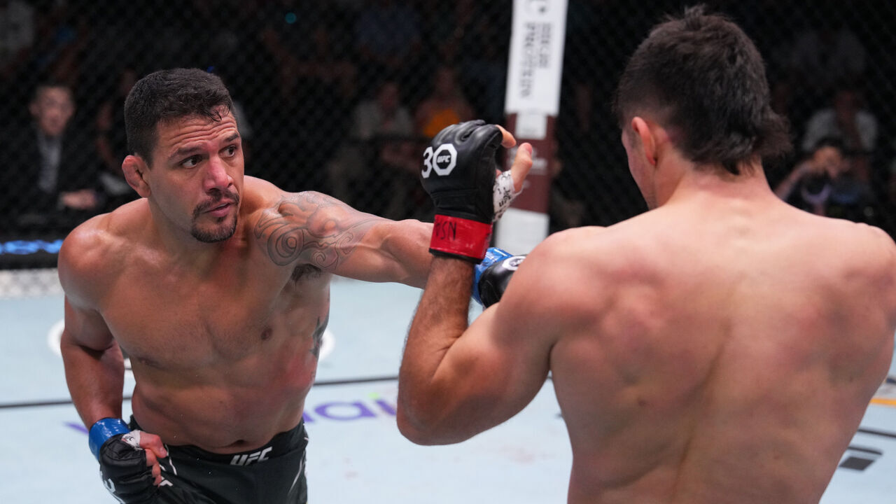 LAS VEGAS, NEVADA - AUGUST 12: (L-R) Rafael Dos Anjos of Brazil punches Vicente Luque in a welterweight fight during the UFC Fight Night event at UFC APEX on August 12, 2023 in Las Vegas, Nevada.
