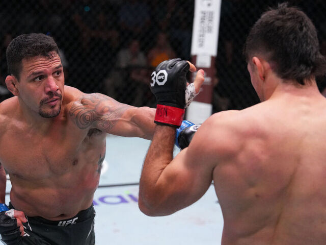LAS VEGAS, NEVADA - AUGUST 12: (L-R) Rafael Dos Anjos of Brazil punches Vicente Luque in a welterweight fight during the UFC Fight Night event at UFC APEX on August 12, 2023 in Las Vegas, Nevada.