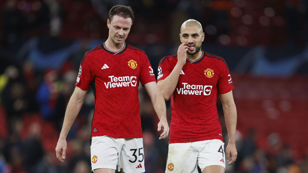 MANCHESTER, ENGLAND - DECEMBER 12: Jonny Evans and Sofyan Amrabat of Manchester United look dejected after the UEFA Champions League match between Manchester United and FC Bayern Munchen at Old Trafford on December 12, 2023 in Manchester, England.