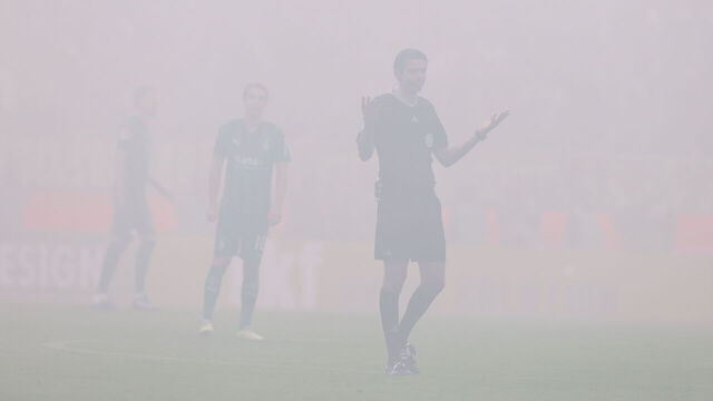COLOGNE, GERMANY - OCTOBER 22: Referee Deniz Aytekin gestures in the fog of fireworks and pyrotechnics during the Bundesliga match between 1. FC Köln and Borussia Mönchengladbach at RheinEnergieStadion on October 22, 2023 in Cologne, Germany.