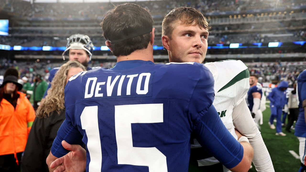 EAST RUTHERFORD, NEW JERSEY - OCTOBER 29: Tommy DeVito #15 of the New York Giants hugs Zach Wilson #2 of the New York Jets after the Jets' 13-10 overtime win at MetLife Stadium on October 29, 2023 in East Rutherford, New Jersey.