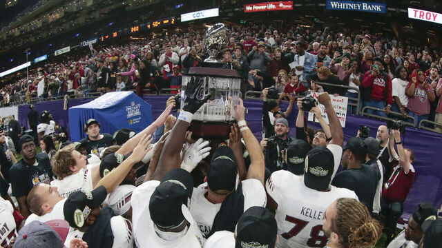 NEW ORLEANS, LA - DECEMBER 16: Troy players present the trophy to the fans during the New Orleans Bowl between North Texas and Troy on December 16, 2017, at the Mercedes-Benz Superdome in New Orleans, LA.