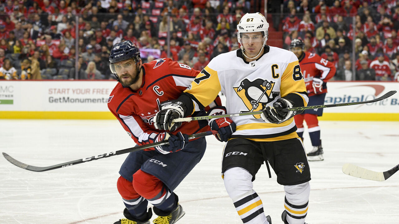 WASHINGTON, DC - NOVEMBER 10: Washington Capitals left wing Alex Ovechkin (8) and Pittsburgh Penguins center Sidney Crosby (87) fight for a second period puck on November 10, 2017, at the Capital One Arena in Washington, D.C.