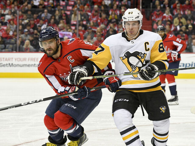 WASHINGTON, DC - NOVEMBER 10: Washington Capitals left wing Alex Ovechkin (8) and Pittsburgh Penguins center Sidney Crosby (87) fight for a second period puck on November 10, 2017, at the Capital One Arena in Washington, D.C.