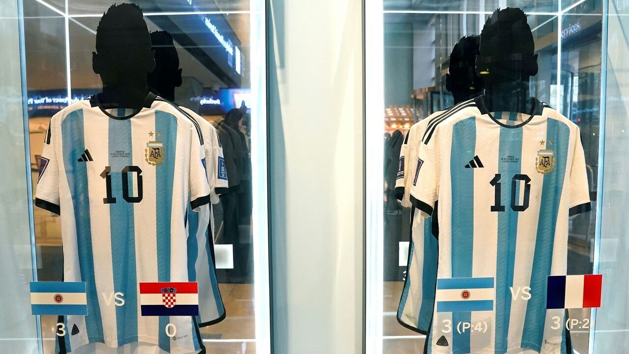 The shirt worn in the 2022 World Cup semi-final match between Argentina and Croatia on December 13, 2022 (L), and the shirt worn in the 2022 World Cup final match between Argentina and France on December 18, 2022 (R), are displayed during a Sotheby's auction media preview of six 2022 FIFA World Cup match-worn shirts belonging to Inter Miami's Argentine forward #10 Lionel Messi, in New York City on November 30, 2023. The auction, which includes shirts worn in the final, semi-final, quarter-final, round of 16, and key group stage matches, is open for bidding from November 30, 2023, to December 14, 2023.