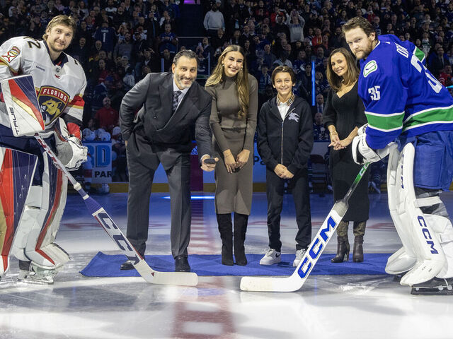 VANCOUVER, CANADA - DECEMBER 14: Forner Vancouver Canucks goaltender Roberto Luongo and his family take part in a ceremonial face-off with Thatcher Demko #35 of the Vancouver Canucks and Sergei Bobrovsky #72 of the Florida Panthers before their NHL game at Rogers Arena on December 14, 2023 in Vancouver, British Columbia, Canada.