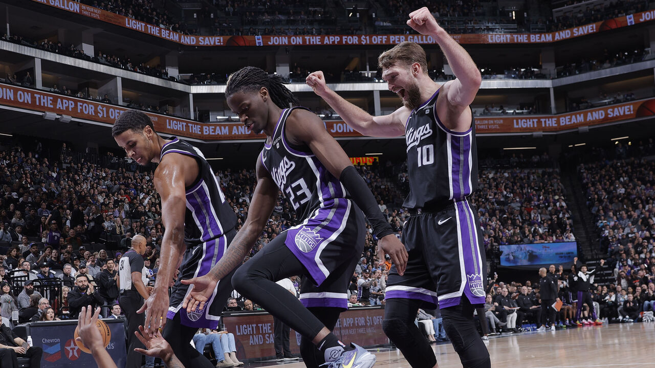 SACRAMENTO, CA - DECEMBER 14: Malik Monk #0 of the Sacramento Kings is helped up by Keegan Murray #13, Keon Ellis #23 and Domantas Sabonis #10 during the game against the Oklahoma City Thunder on December 14, 2023 at Golden 1 Center in Sacramento, California. Mandatory Copyright Notice: Copyright 2023 NBAE