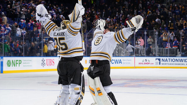ELMONT, NEW YORK - DECEMBER 15: Linus Ullmark #35 and Jeremy Swayman #1 of the Boston Bruins celebrate win in shoot out at UBS Arena on December 15, 2023 in Elmont, New York.