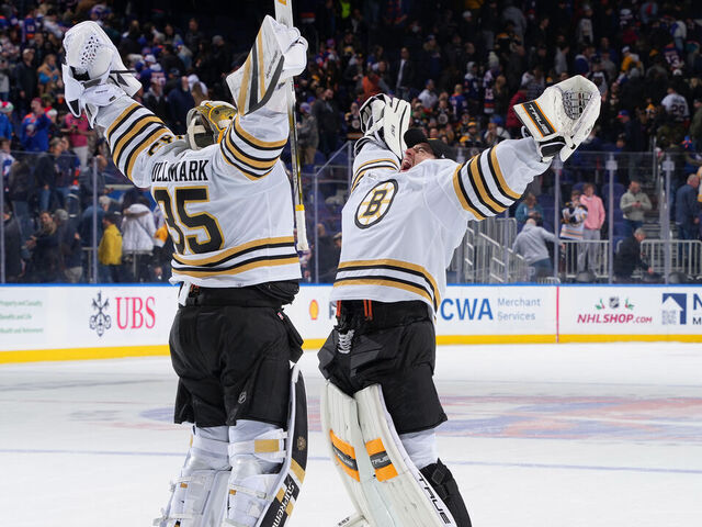 ELMONT, NEW YORK - DECEMBER 15: Linus Ullmark #35 and Jeremy Swayman #1 of the Boston Bruins celebrate win in shoot out at UBS Arena on December 15, 2023 in Elmont, New York.