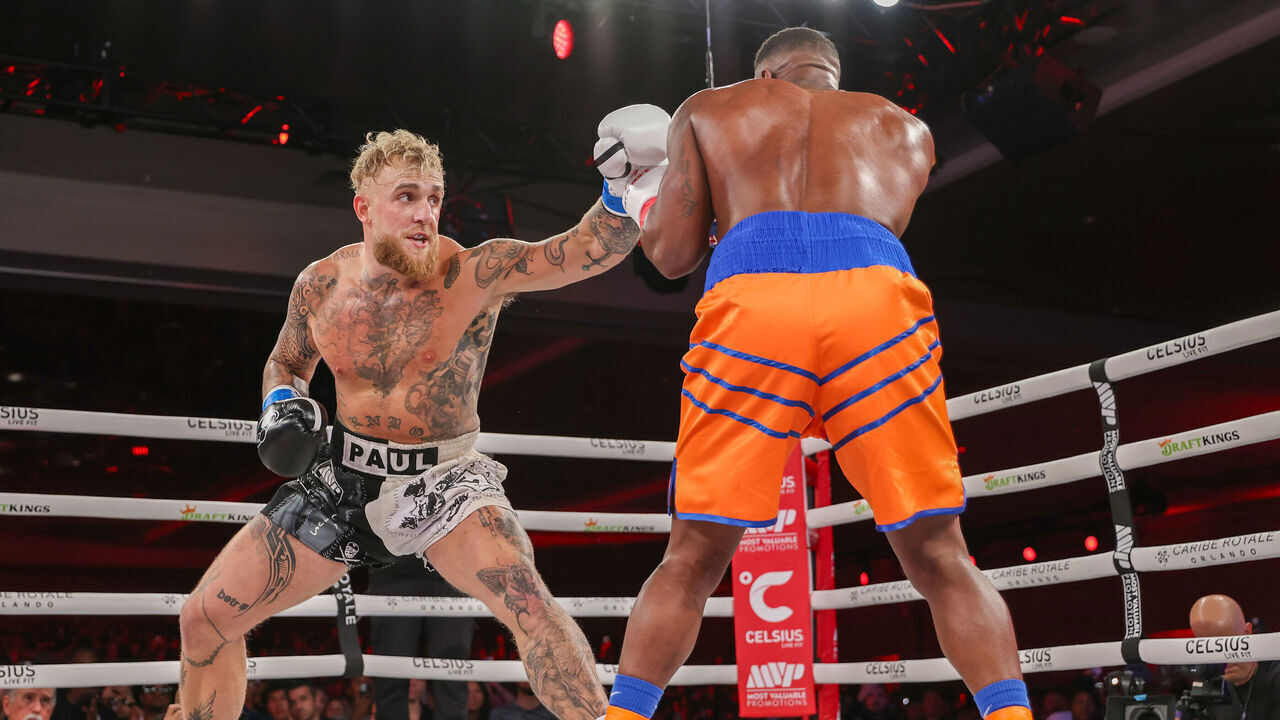 ORLANDO, FL - DECEMBER 15: Jake Paul punches Andre August during the Jake Paul v Andre August at the Caribe Royale Orlando on December 15 2023 in Orlando, Florida.