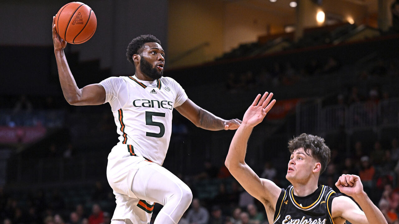 CORAL GABLES, FL - DECEMBER 16: Miami guard Wooga Poplar (5) dunks the ball over La Salle forward Rokas Jocius (35) in the first half as the Miami Hurricanes faced the La Salle Explorers on December 16, 2023, at the Watsco Center in Coral Gables, Florida.