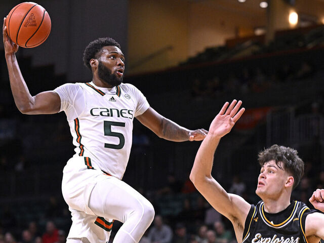 CORAL GABLES, FL - DECEMBER 16: Miami guard Wooga Poplar (5) dunks the ball over La Salle forward Rokas Jocius (35) in the first half as the Miami Hurricanes faced the La Salle Explorers on December 16, 2023, at the Watsco Center in Coral Gables, Florida.