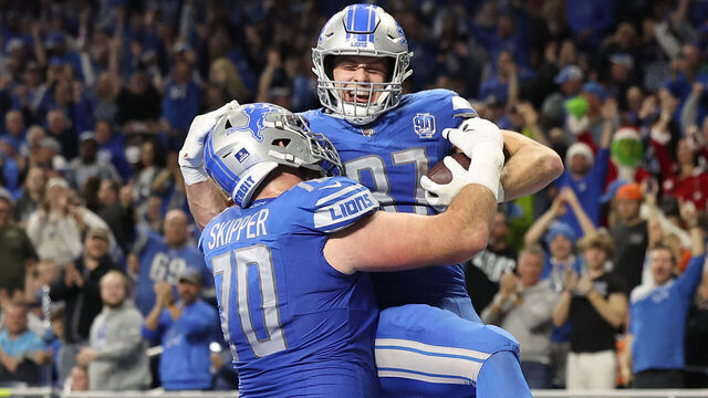 DETROIT, MICHIGAN - DECEMBER 16: Sam LaPorta #87 of the Detroit Lions celebrates his touchdown catch with Dan Skipper #70 during the fourth quarter against the Denver Broncos at Ford Field on December 16, 2023 in Detroit, Michigan.