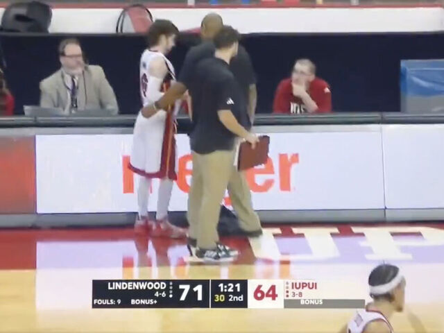 Fan in LeBron uniform tries to check into college basketball game