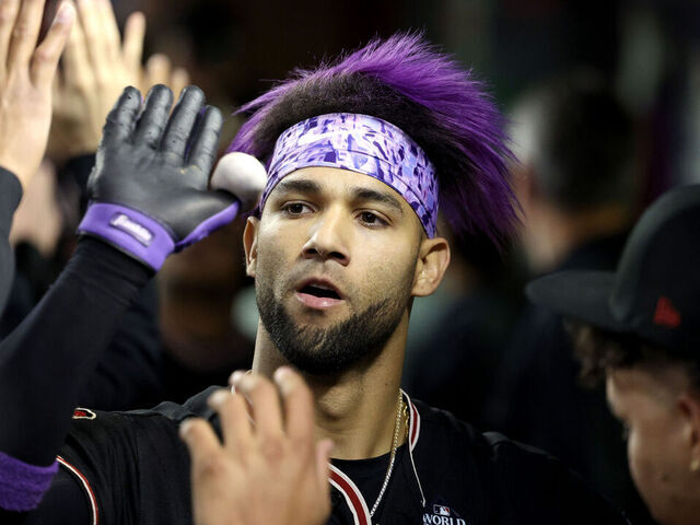 PHOENIX, ARIZONA - OCTOBER 31: Lourdes Gurriel Jr. #12 of the Arizona Diamondbacks celebrates with teammates after hitting a home run in the eighth inning against the Texas Rangers during Game Four of the World Series at Chase Field on October 31, 2023 in Phoenix, Arizona.
