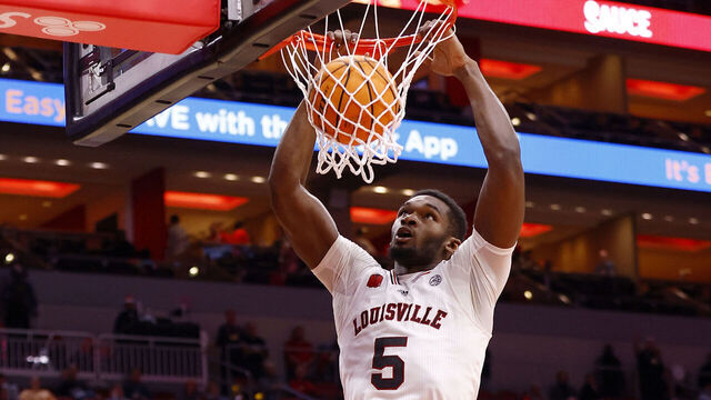 LOUISVILLE, KY - DECEMBER 17: Louisville Cardinals forward Brandon Huntley-Hatfield (5) slams down the dunk during a mens college basketball game between the Pepperdine Waves and the Louisville Cardinals on December 17, 2023 at KFC Yum! Center in Louisville, KY.