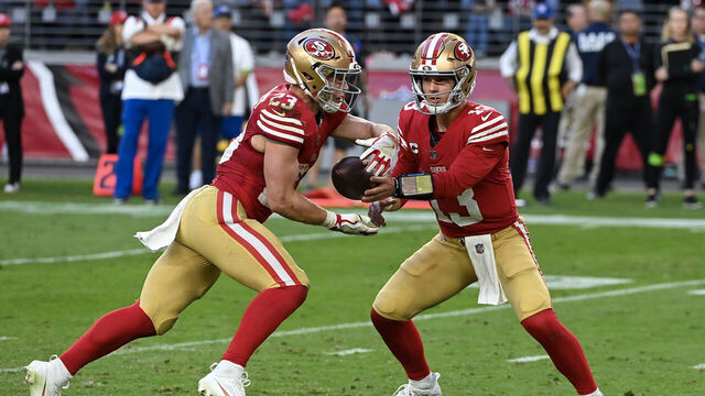 GLENDALE, ARIZONA - DECEMBER 17: Brock Purdy #13 of the San Francisco 49ers hands the ball off to Christian McCaffrey #23 of the San Francisco 49ers during the fourth quarter against the Arizona Cardinals at State Farm Stadium on December 17, 2023 in Glendale, Arizona.