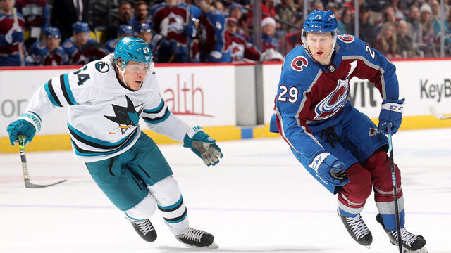DENVER, COLORADO - DECEMBER 17: Nathan MacKinnon #29 of the Colorado Avalanche skates against Mitchell Russell #64 of the San Jose Sharks at Ball Arena on December 17, 2023 in Denver, Colorado.