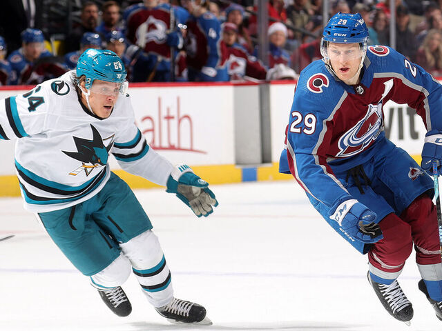DENVER, COLORADO - DECEMBER 17: Nathan MacKinnon #29 of the Colorado Avalanche skates against Mitchell Russell #64 of the San Jose Sharks at Ball Arena on December 17, 2023 in Denver, Colorado.