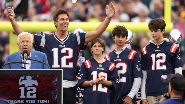 FOXBOROUGH, MASSACHUSETTS - SEPTEMBER 10: New England Patriots owner Robert Kraft speaks while former New England Patriots quarterback Tom Brady reacts while Brady's children, Vivian, Benjamin, and Jack, look on during a ceremony honoring Brady at halftime of New England's game against the Philadelphia Eagles at Gillette Stadium on September 10, 2023 in Foxborough, Massachusetts.