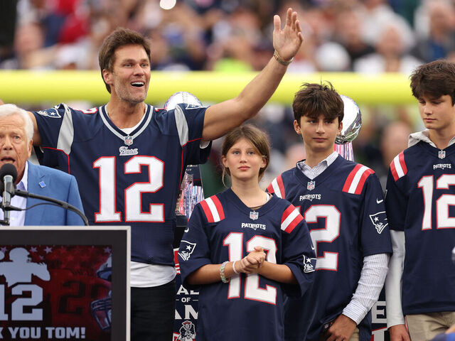 FOXBOROUGH, MASSACHUSETTS - SEPTEMBER 10: New England Patriots owner Robert Kraft speaks while former New England Patriots quarterback Tom Brady reacts while Brady's children, Vivian, Benjamin, and Jack, look on during a ceremony honoring Brady at halftime of New England's game against the Philadelphia Eagles at Gillette Stadium on September 10, 2023 in Foxborough, Massachusetts.
