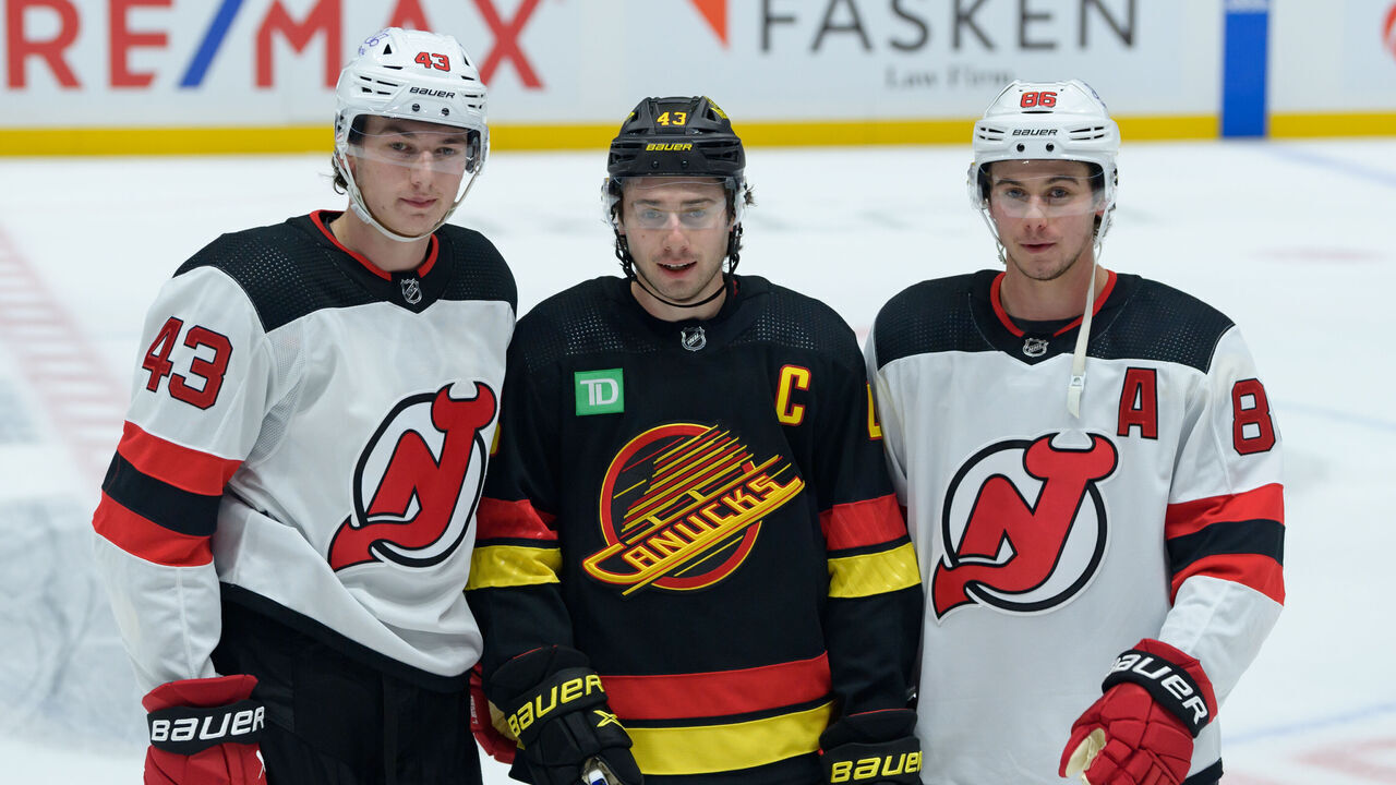 VANCOUVER, CANADA - DECEMBER 5: Brothers Luke Hughes #43 of the New Jersey Devils Quinn Hughes #43 of the Vancouver Canucks and Jack Hughes #86 of the New Jersey Devils pose for a photo prior to their NHL game at Rogers Arena on December 5, 2023 in Vancouver, British Columbia, Canada.