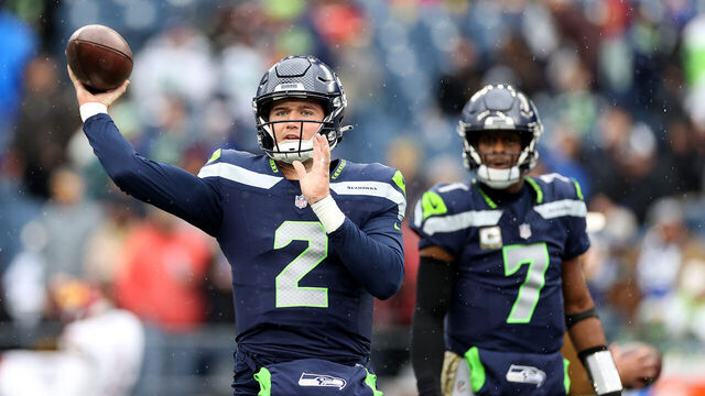 SEATTLE, WASHINGTON - NOVEMBER 12: Drew Lock #2 and Geno Smith #7 of the Seattle Seahawks warm up before the game against the Washington Commanders at Lumen Field on November 12, 2023 in Seattle, Washington.