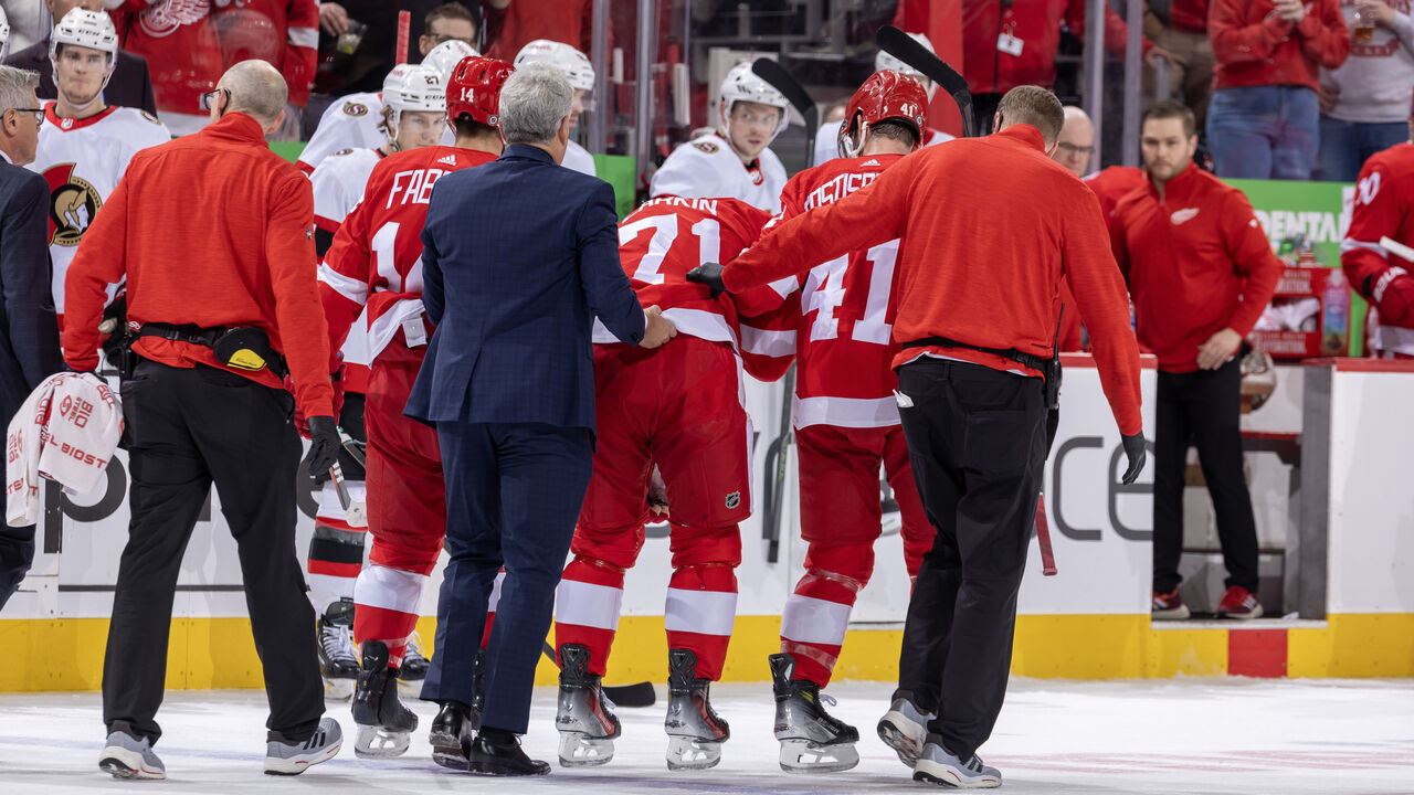 DETROIT, MI - DECEMBER 09: Dylan Larkin #71 of the Detroit Red Wings is helped off the ice by the team medical staff after being injured during the first period of the game against the Ottawa Senators at Little Caesars Arena on December 9, 2023 in Detroit, Michigan.