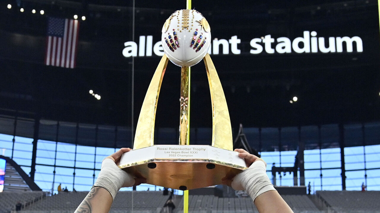 LAS VEGAS, NEVADA - DECEMBER 17: Heneli Bloomfield #58 of the Oregon State Beavers hoists up the championship trophy as he stands with teammates after the Beavers defeated the Florida Gators 30-3 in the SRS Distribution Las Vegas Bowl at Allegiant Stadium on December 17, 2022 in Las Vegas, Nevada.