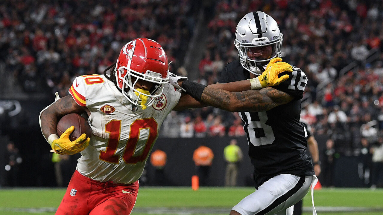 LAS VEGAS, NEVADA - NOVEMBER 26: Isiah Pacheco #10 of the Kansas City Chiefs runs with the ball as Jack Jones #18 of the Las Vegas Raiders defends during the fourth quarter at Allegiant Stadium on November 26, 2023 in Las Vegas, Nevada.