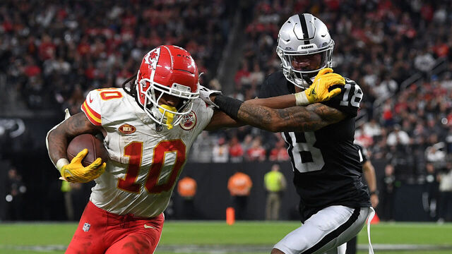 LAS VEGAS, NEVADA - NOVEMBER 26: Isiah Pacheco #10 of the Kansas City Chiefs runs with the ball as Jack Jones #18 of the Las Vegas Raiders defends during the fourth quarter at Allegiant Stadium on November 26, 2023 in Las Vegas, Nevada.
