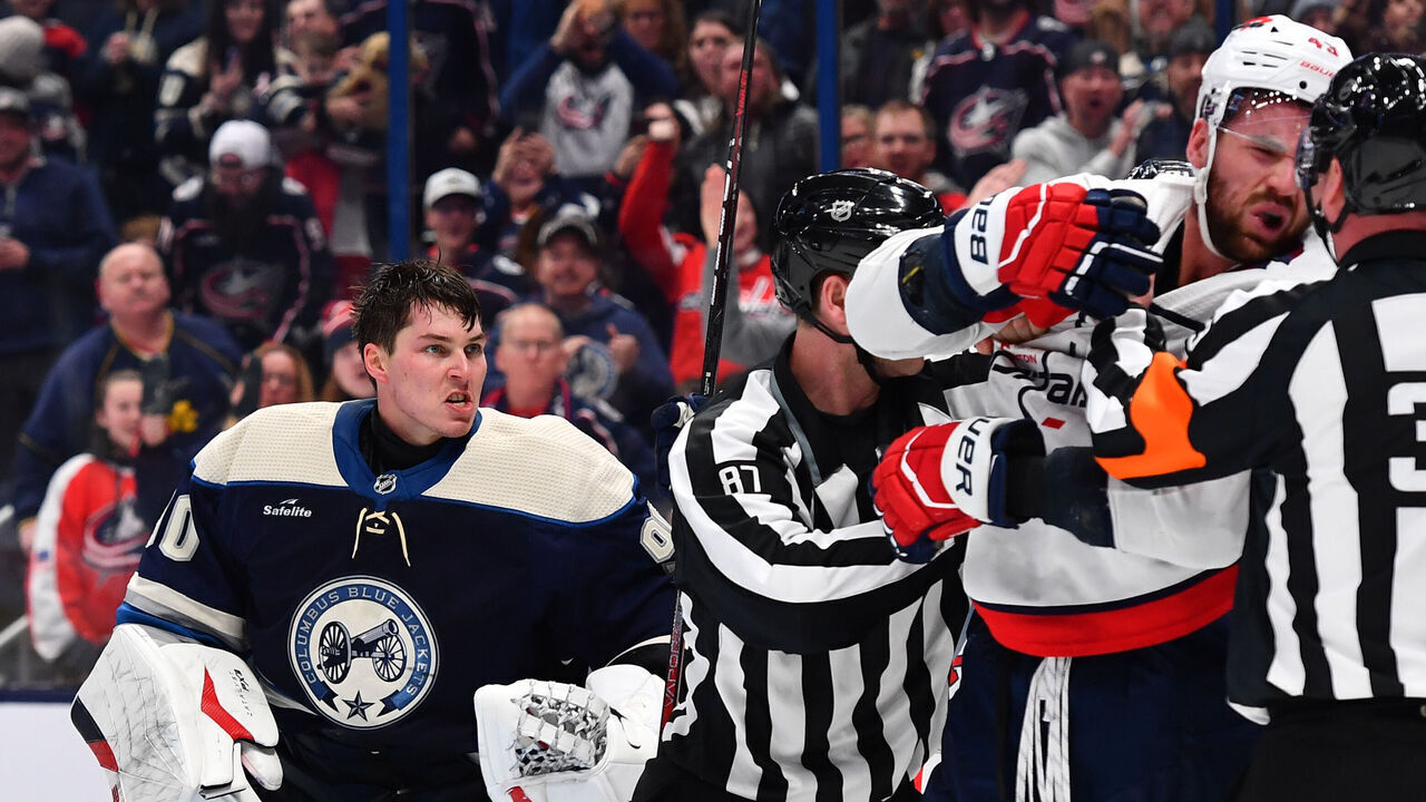 COLUMBUS, OHIO - DECEMBER 21: Linesmen Devin Berg #87 breaks up a scuffle between goaltender Elvis Merzlikins #90 of the Columbus Blue Jackets and Tom Wilson #43 of the Washington Capitals during the third period of a game at Nationwide Arena on December 21, 2023 in Columbus, Ohio.