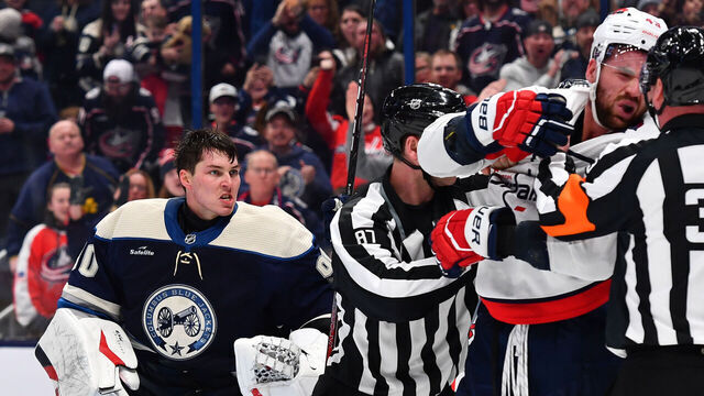 COLUMBUS, OHIO - DECEMBER 21: Linesmen Devin Berg #87 breaks up a scuffle between goaltender Elvis Merzlikins #90 of the Columbus Blue Jackets and Tom Wilson #43 of the Washington Capitals during the third period of a game at Nationwide Arena on December 21, 2023 in Columbus, Ohio.