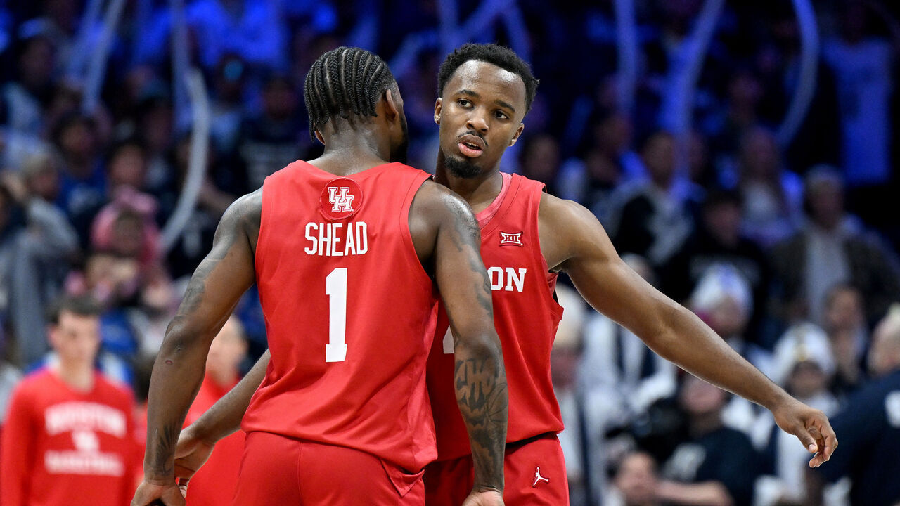 CINCINNATI, OHIO - DECEMBER 01: LJ Cryer #4 of the Houston Cougars celebrates with Jamal Shead #1 during the game against the Xavier Musketeers at Cintas Center on December 01, 2023 in Cincinnati, Ohio.