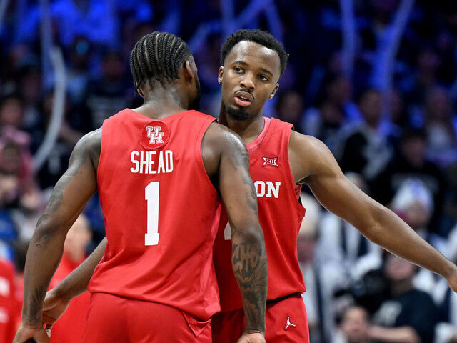 CINCINNATI, OHIO - DECEMBER 01: LJ Cryer #4 of the Houston Cougars celebrates with Jamal Shead #1 during the game against the Xavier Musketeers at Cintas Center on December 01, 2023 in Cincinnati, Ohio.